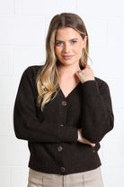 Rant & Rave Claire Cardigan in dark brown, side model view with hand near collar