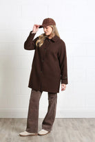 Rant & Rave Georgia Coat in chocolate brown worn by model, angled view adjusting hat