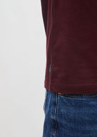 Diesel John Tee in deep burgundy, detail view of side hem tag