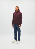 Diesel Julian hoodie in deep burgundy, angled model view with jeans and white sneakers