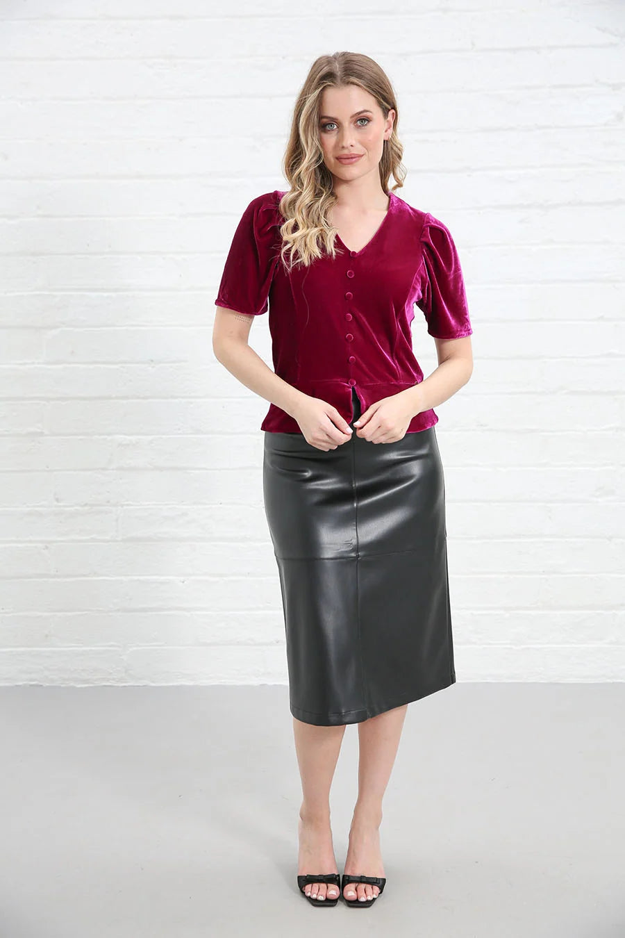 Rant & Rave Matilda Velvet Top Pink, front view worn by model with hands at hem, V-neck button detail visible