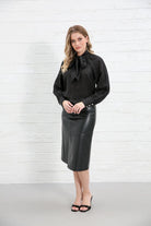 Rant & Rave Natalia Top Black worn by model, angled front view with cuffed sleeves