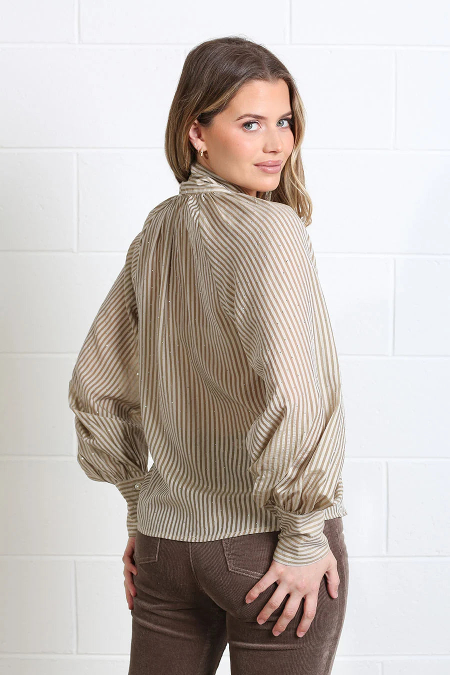 Rant & Rave Natalia top in Light Coffee, back angled model view with striped fabric and long sleeves.
