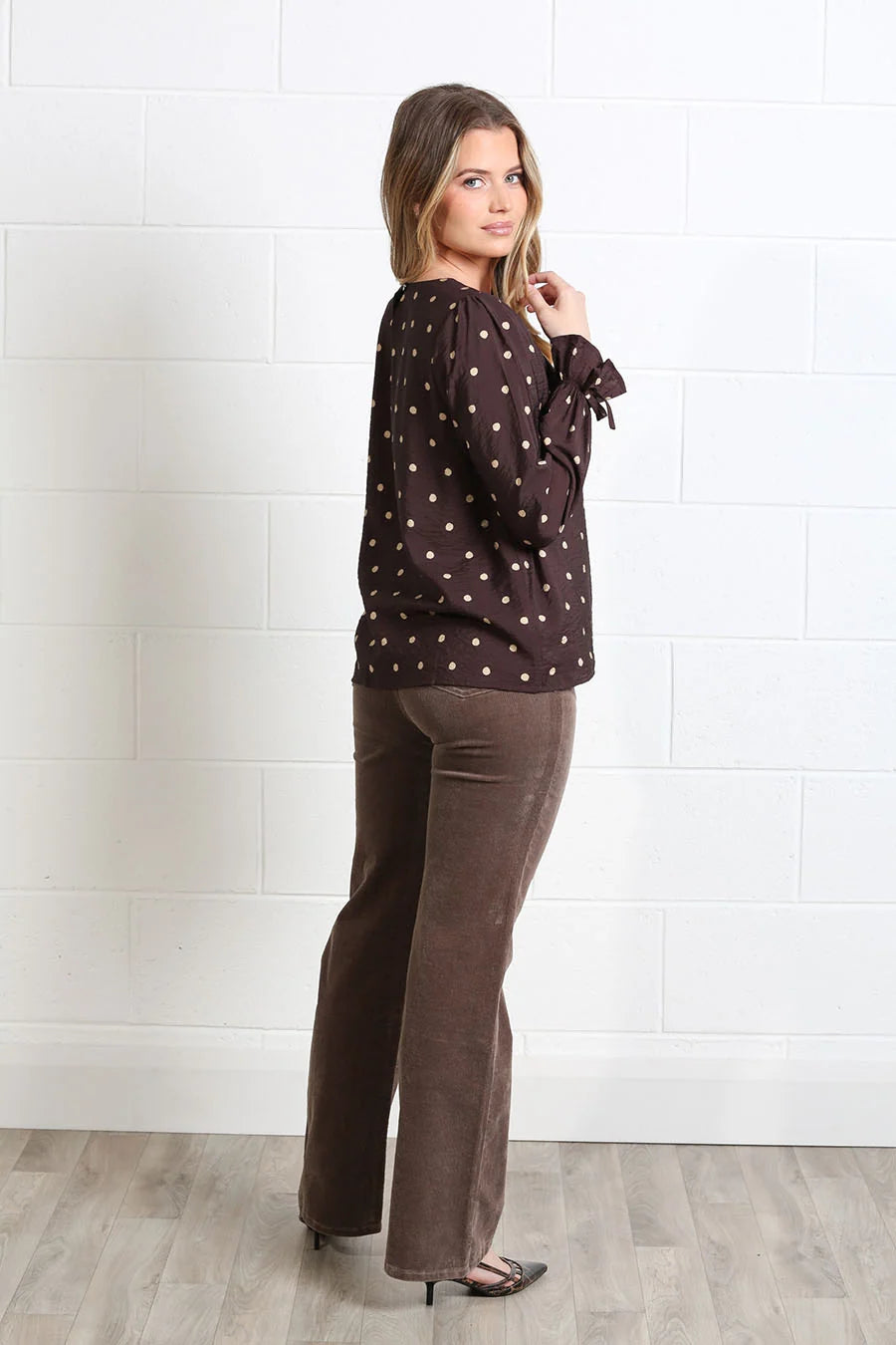 Rant & Rave Sophia Top in chocolate polka dot, side model view highlighting relaxed fit and sleeve ties.