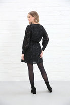 Rant & Rave Susannah Wrap Dress in black, back view worn by a model with long sleeves and short hem