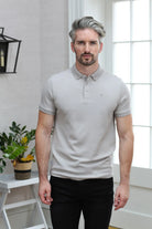 Kenrow Brett Polo in putty worn by a model, front close - up view showing collar and chest logo.