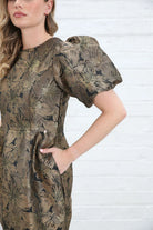 Rant & Rave Evelyn Dress in black and gold floral jacquard, detail view of puff sleeve, round neck and pocket.