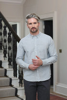 Kenrow Fritz Shirt in light grey worn by model, angled front view near staircase.