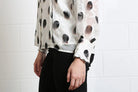 Rant & Rave Posy blouse in white, detail view of sheer sleeve and scalloped cuff.