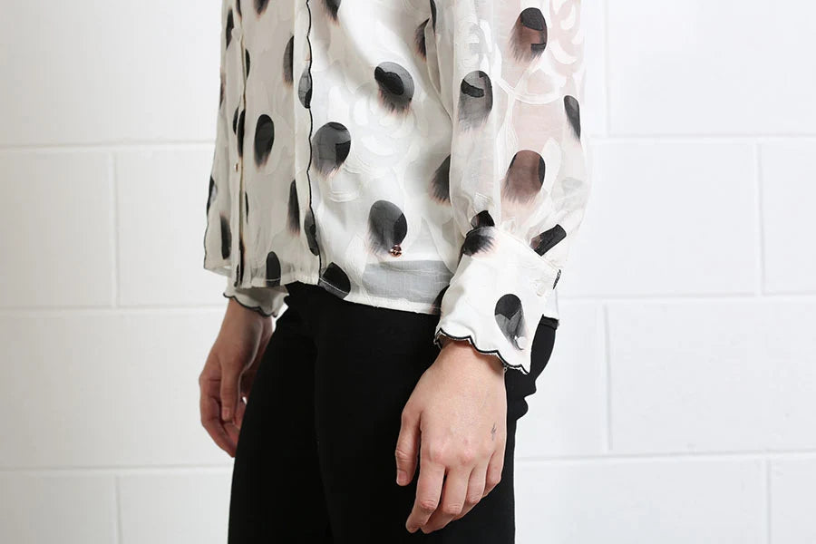 Rant & Rave Posy blouse in white, detail view of sheer sleeve and scalloped cuff.