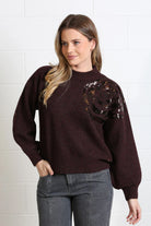 Rant & Rave Sarah Jumper in burgundy worn by model, angled view with hand in pocket