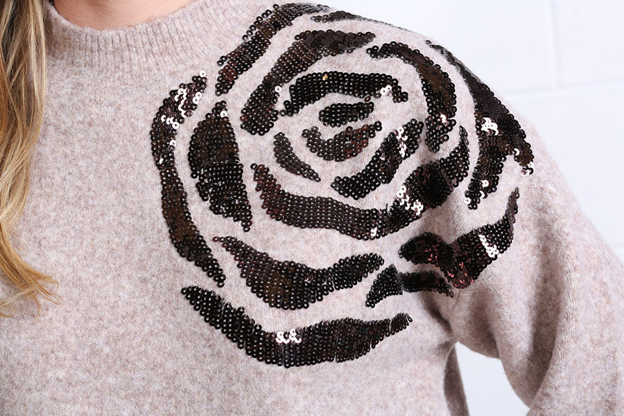 Detail view of the black sequin rose embellishment on the Rant & Rave Sarah Jumper in light brown