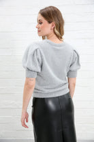 Rant & Rave Victoria Knit Top in silver, back detail view highlighting the shimmering knit fabric, round neckline and puff sleeve shape.