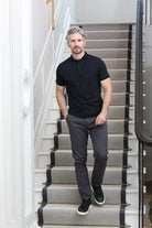 Kenrow Vinny Polo in black worn by model standing on staircase