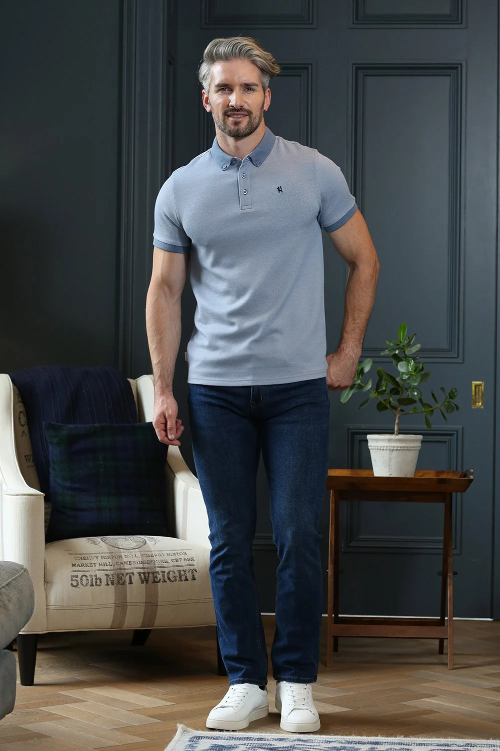 Kenrow Brett Polo Powder Blue full - length model view paired with dark blue jeans, showing the polo's textured body and contrasting collar and cuffs.
