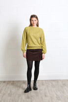 Rant & Rave Charlotte cord skirt in mocha, front model view styled with a knit sweater and ankle boots.