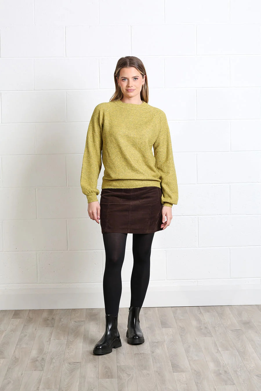Rant & Rave Charlotte cord skirt in mocha, front model view styled with a knit sweater and ankle boots.