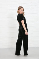 Rant & Rave Clara Trouser Black worn by model, angled back view, wide - leg velvet trousers with matching top