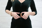 Detail view of Rant & Rave Farrah Jumpsuit green velvet fabric and gold buckle belt