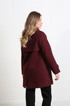 Rant & Rave Georgia Coat in deep port worn by model, angled back view with storm flap and vent