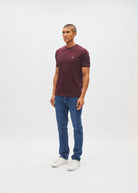 Diesel John Tee in deep burgundy worn by a model, side view