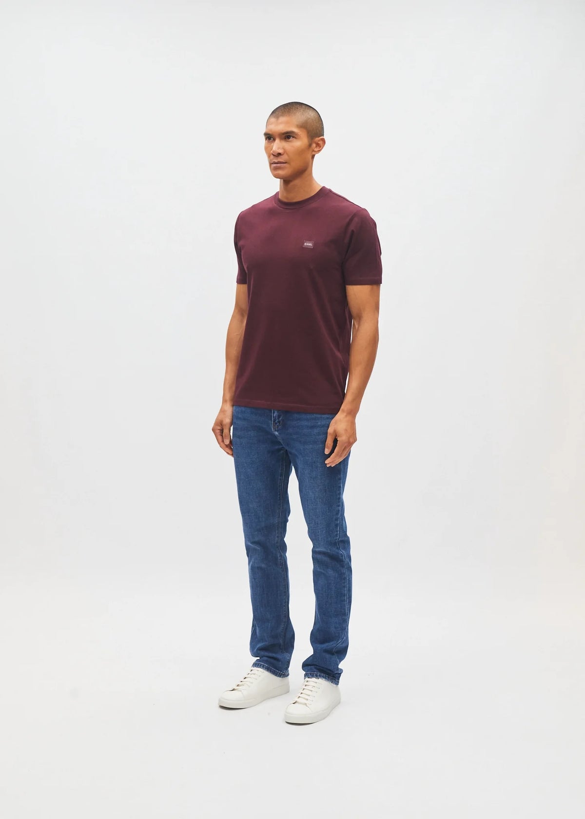 Diesel John Tee in deep burgundy worn by a model, side view