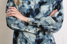 Detail view of the Rant & Rave Leah Top in blue showing cuff buttons and print