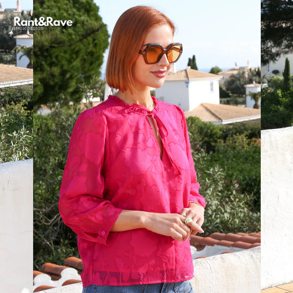 Rant & Rave Primrose top in cerise worn by model, close - up angled view with tie neckline