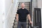 Kenrow Vinny Polo in black worn by model standing by staircase railing