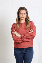 Rant & Rave Zeta Top in terracotta, front model view with textured fabric and gathered long sleeves.