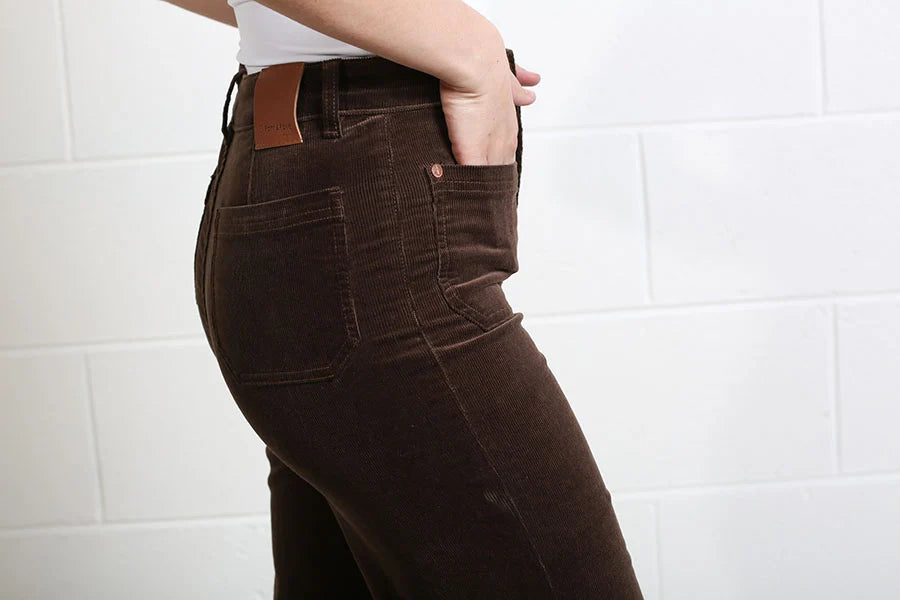 Detail view of the side pocket and Rant & Rave branded leather patch on the mocha Bridget Cord Wide Leg trousers.
