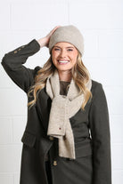 Rant & Rave Olivia Coat deep moss styled with beige scarf and beanie, smiling model close - up