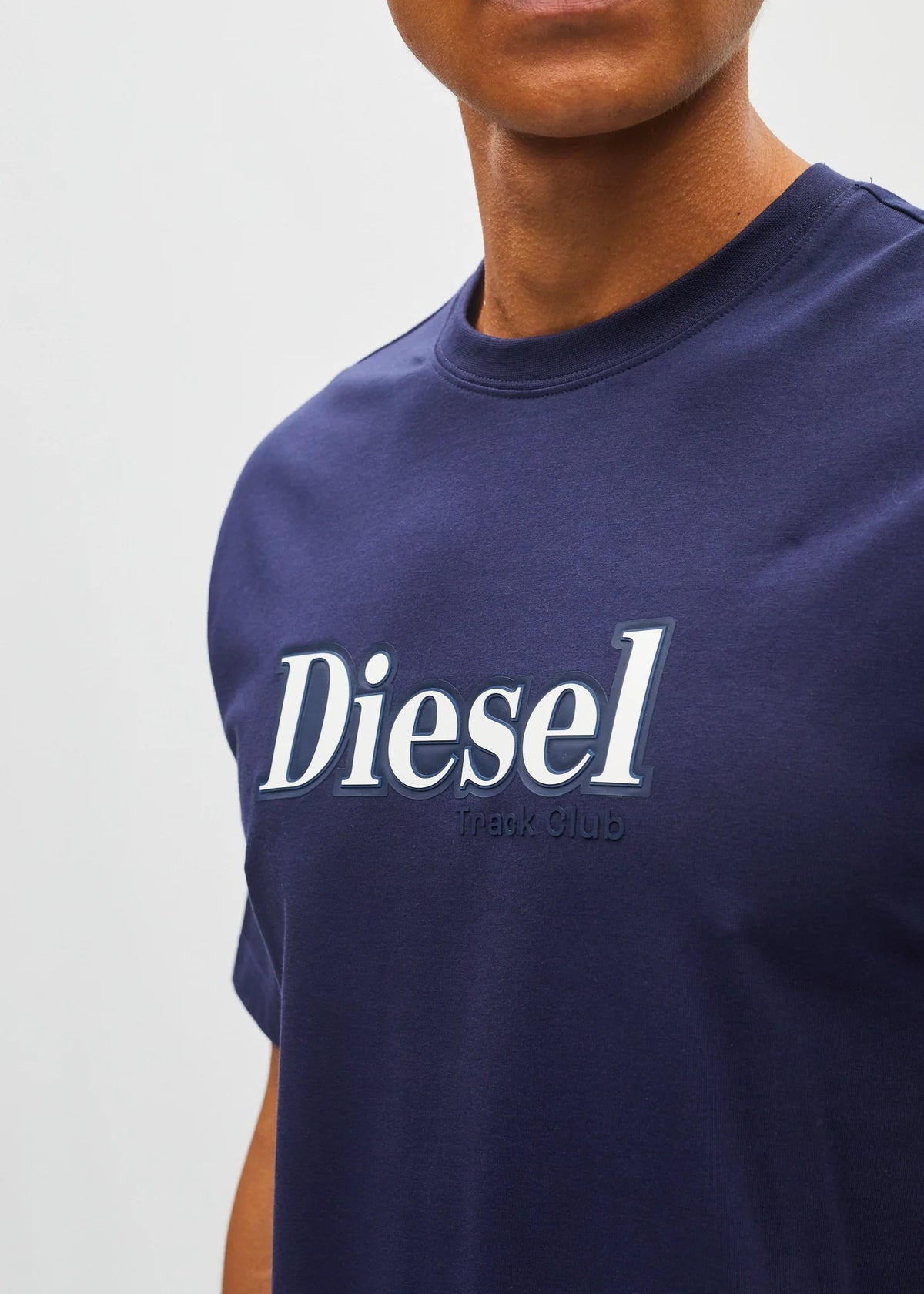 Close - up detail of the Diesel Walter Tee in navy showing the white logo and Track Club text on the chest.