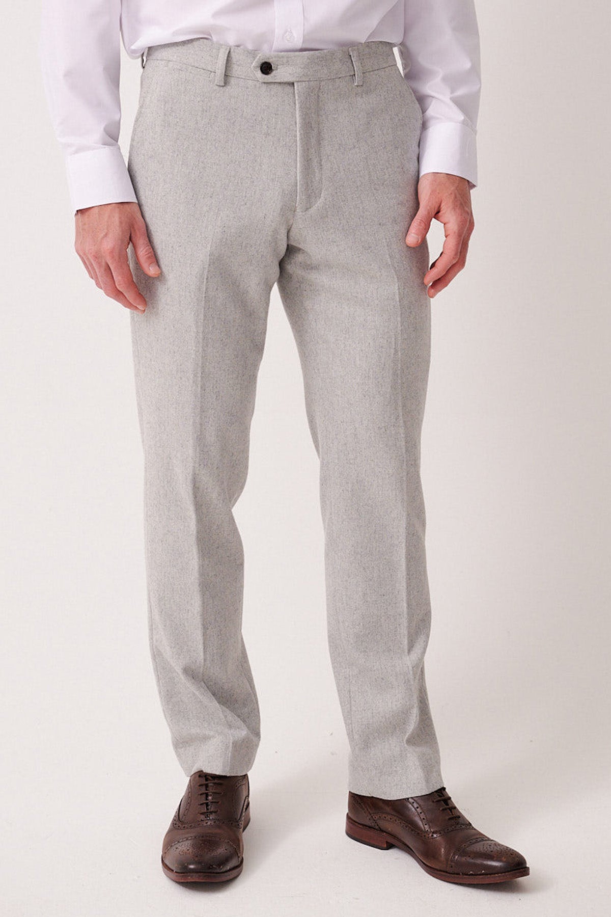 Light gray pants worn by a person on a white background