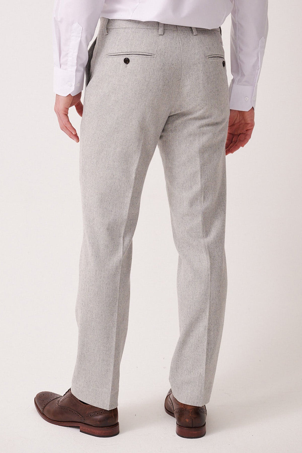 Light gray dress pants worn with a white shirt and brown shoes on a white background