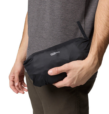 Person holding a black Packable jacket with a visible brand logo.