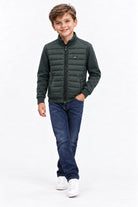 Boy wearing the Diesel Jared olive hybrid jacket with quilted front and zipped pockets.
