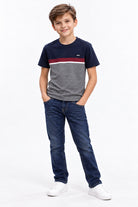 Boy wearing the Diesel Ryan raw indigo jeans, front view styled with the Lenno navy and maroon T-shirt.
