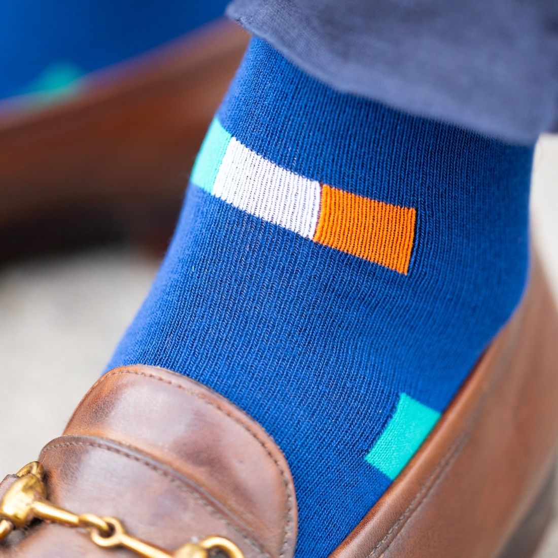Blue sock with irish flags worn with a brown shoe