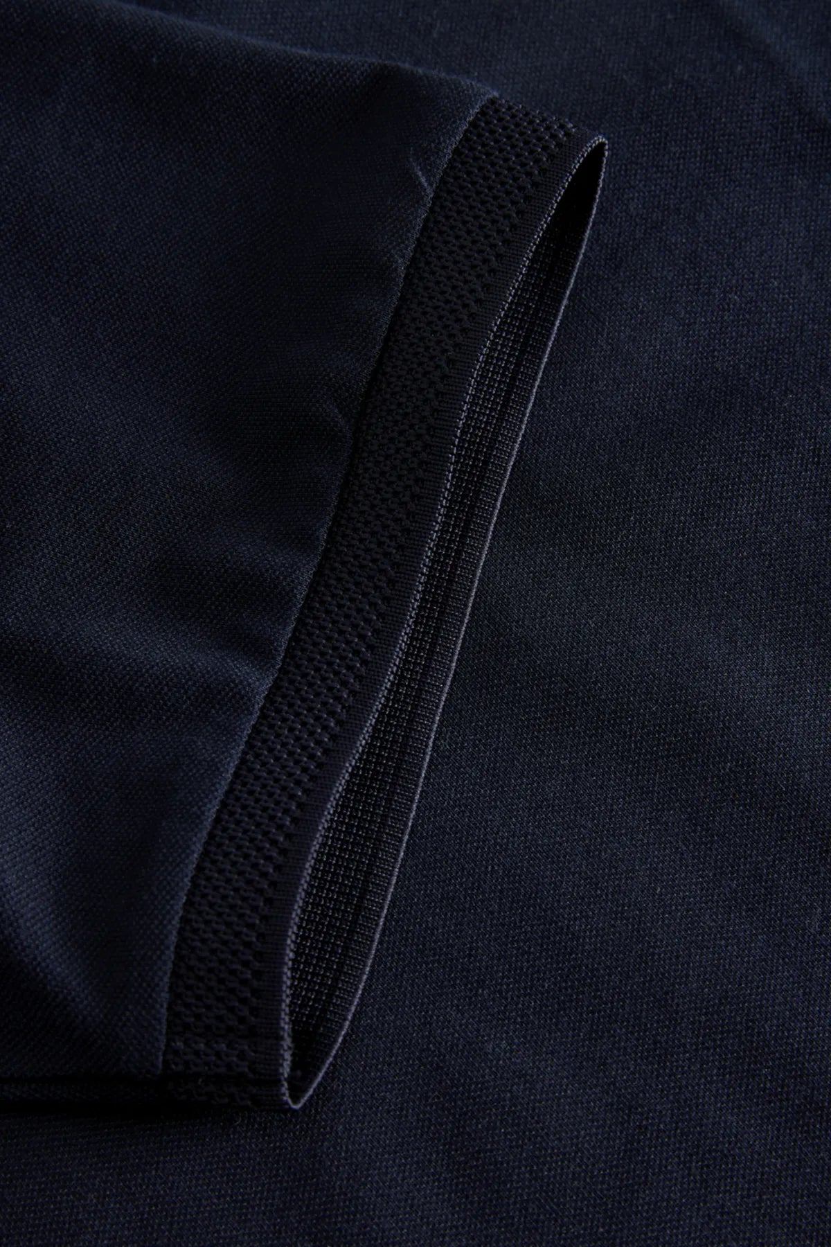 Close-up of a dark blue fabric with a textured band