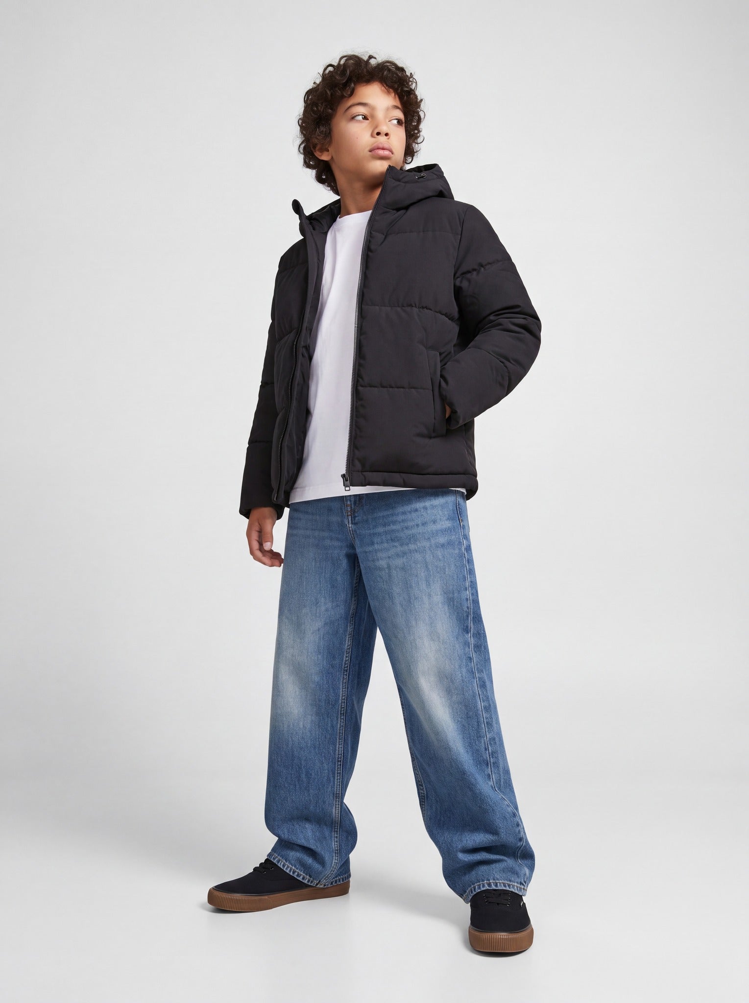 Jack Jones Junior Galaxy Boys Puffer Jacket in Black angled view on model