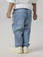 NAME IT Robin Thayers Regular Fit Sweatshirt Trousers in Medium Blue Denim back view on model