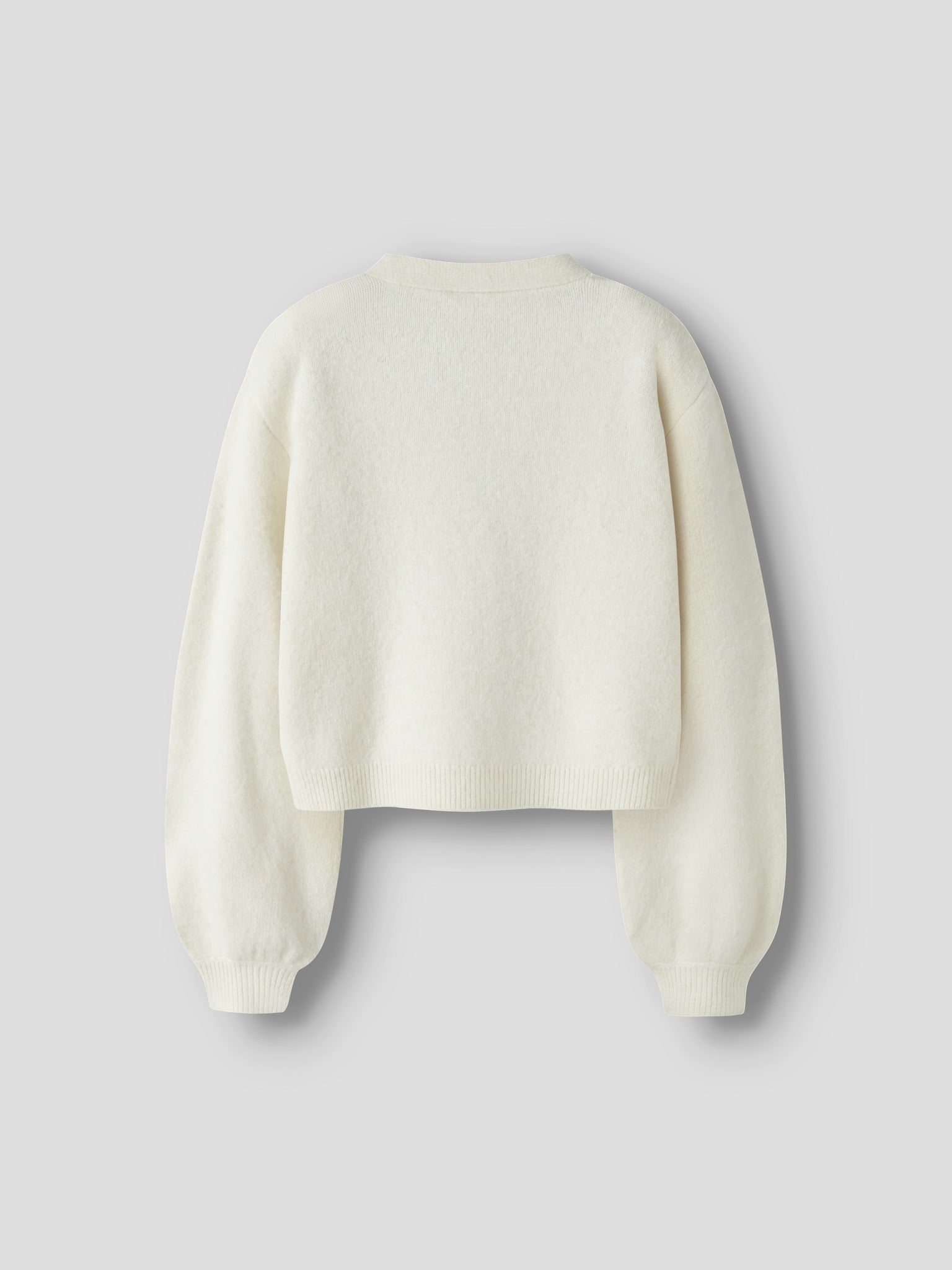 Back view of NAME IT Rina Long Sleeve Knit Cardigan in Antique White Black Bow