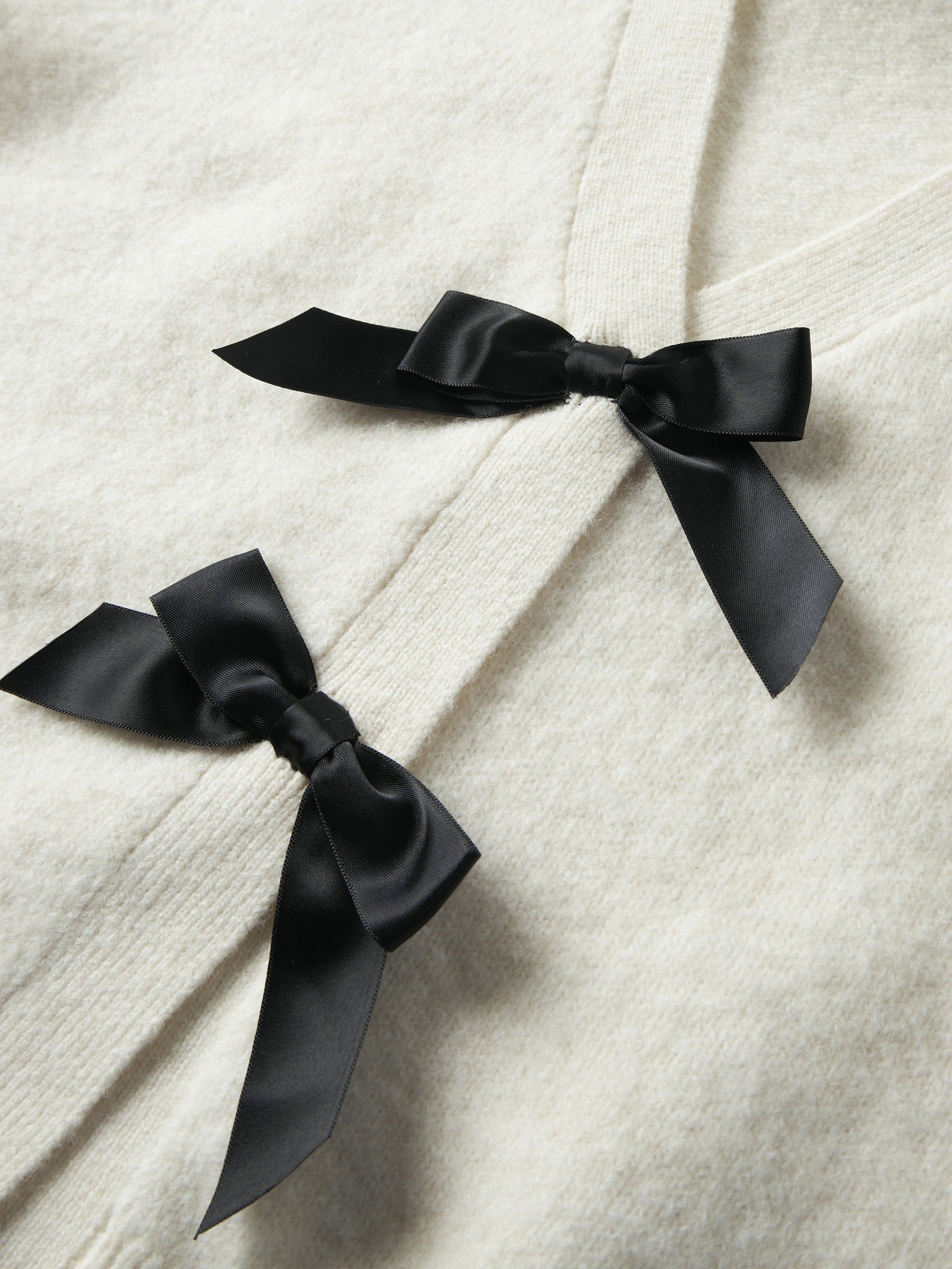Black bow detail on NAME IT Rina Long Sleeve Knit Cardigan in Antique White