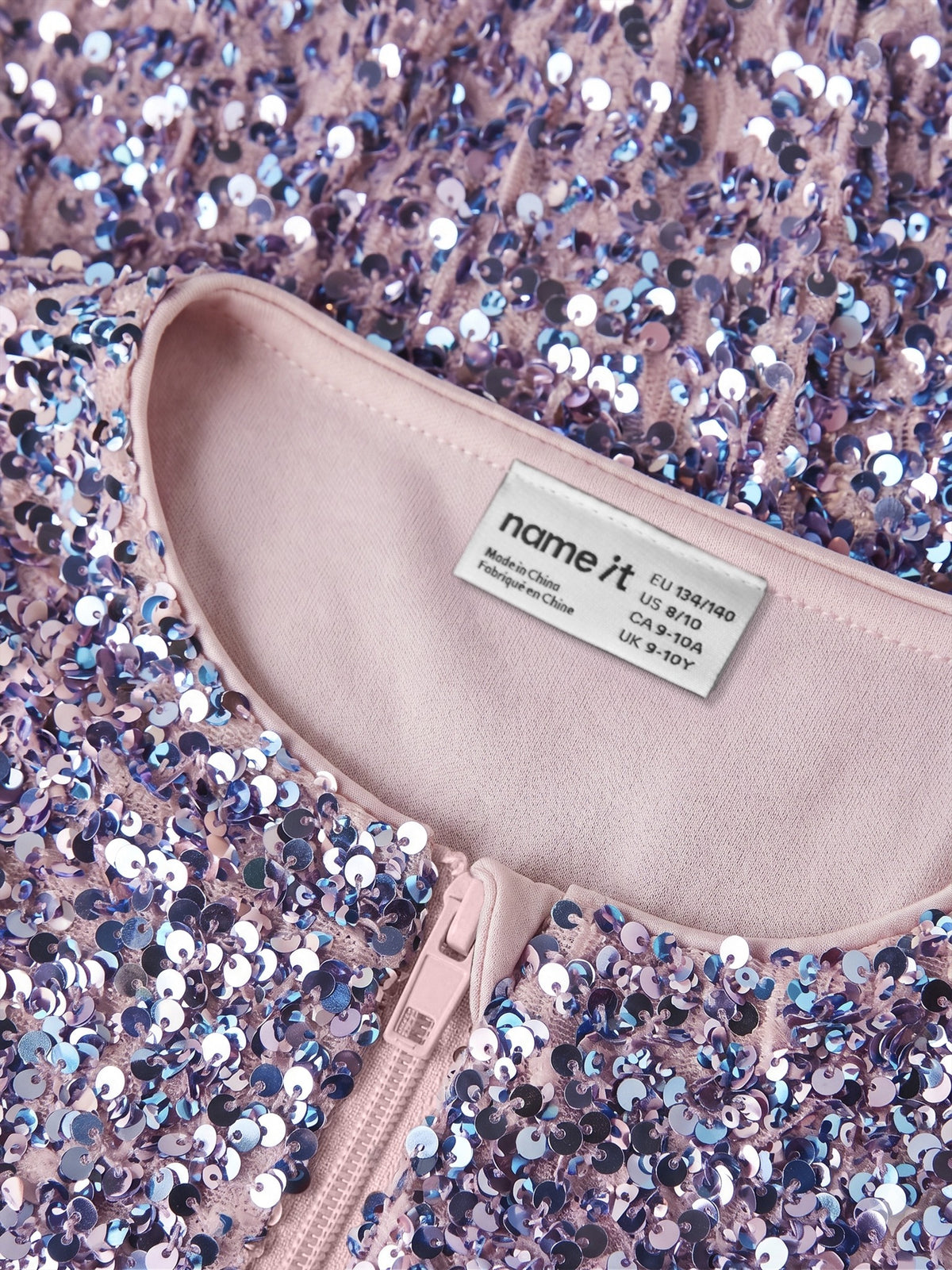 Close-up of the sequins, pink neckline and zip on the NAME IT Runica bomber jacket
