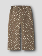 Front view of NAME IT Rammie dot-print sweatpants in Coca Mocha against a grey background