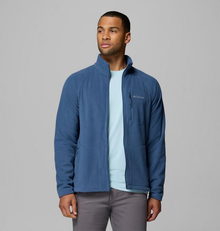 Man wearing a blue fleece jacket with a visible brand logo on a gray background