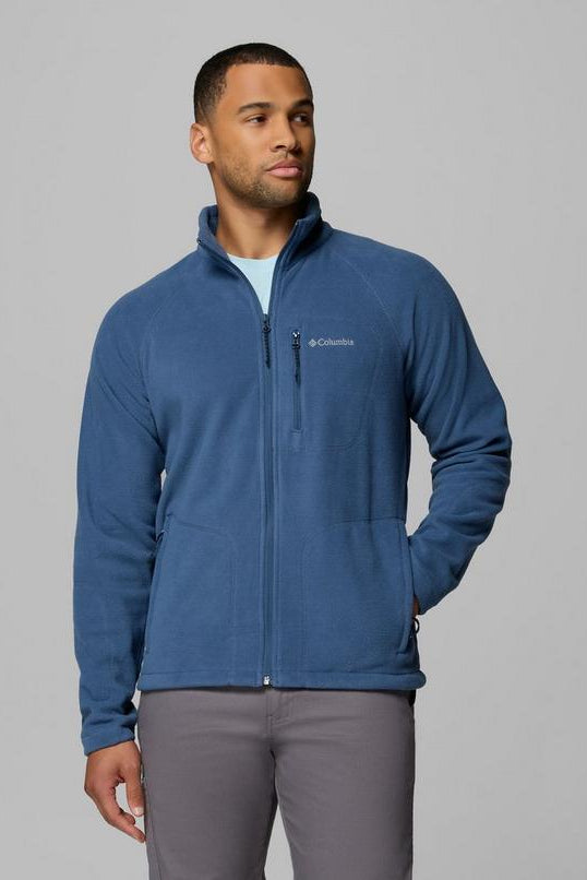 Man wearing a blue fleece jacket with Columbia logo on a gray background