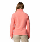 Person wearing a pink jacket on a white background