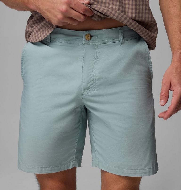 Light blue shorts worn by a person on a gray background